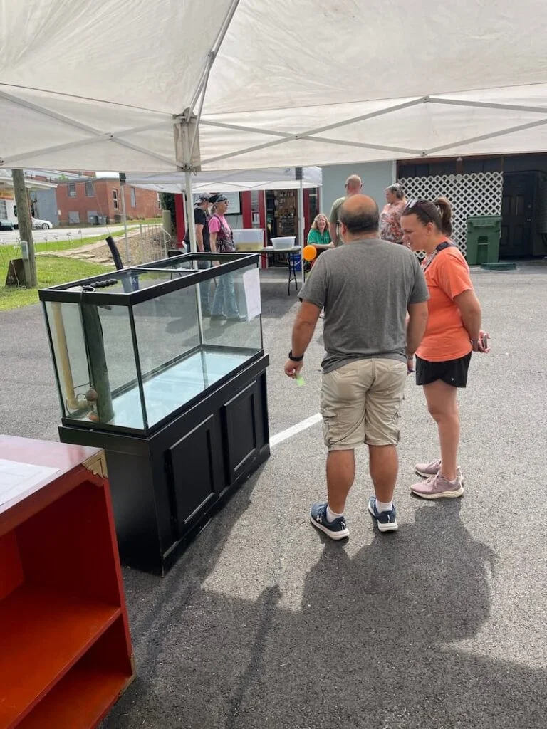 Large aquarium tank during a fish swap event